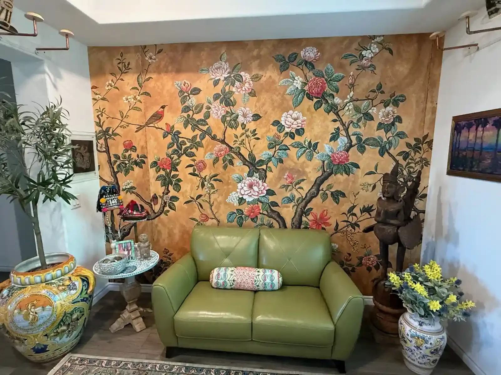 A sitting room with a full-wall botanical wallpaper mural