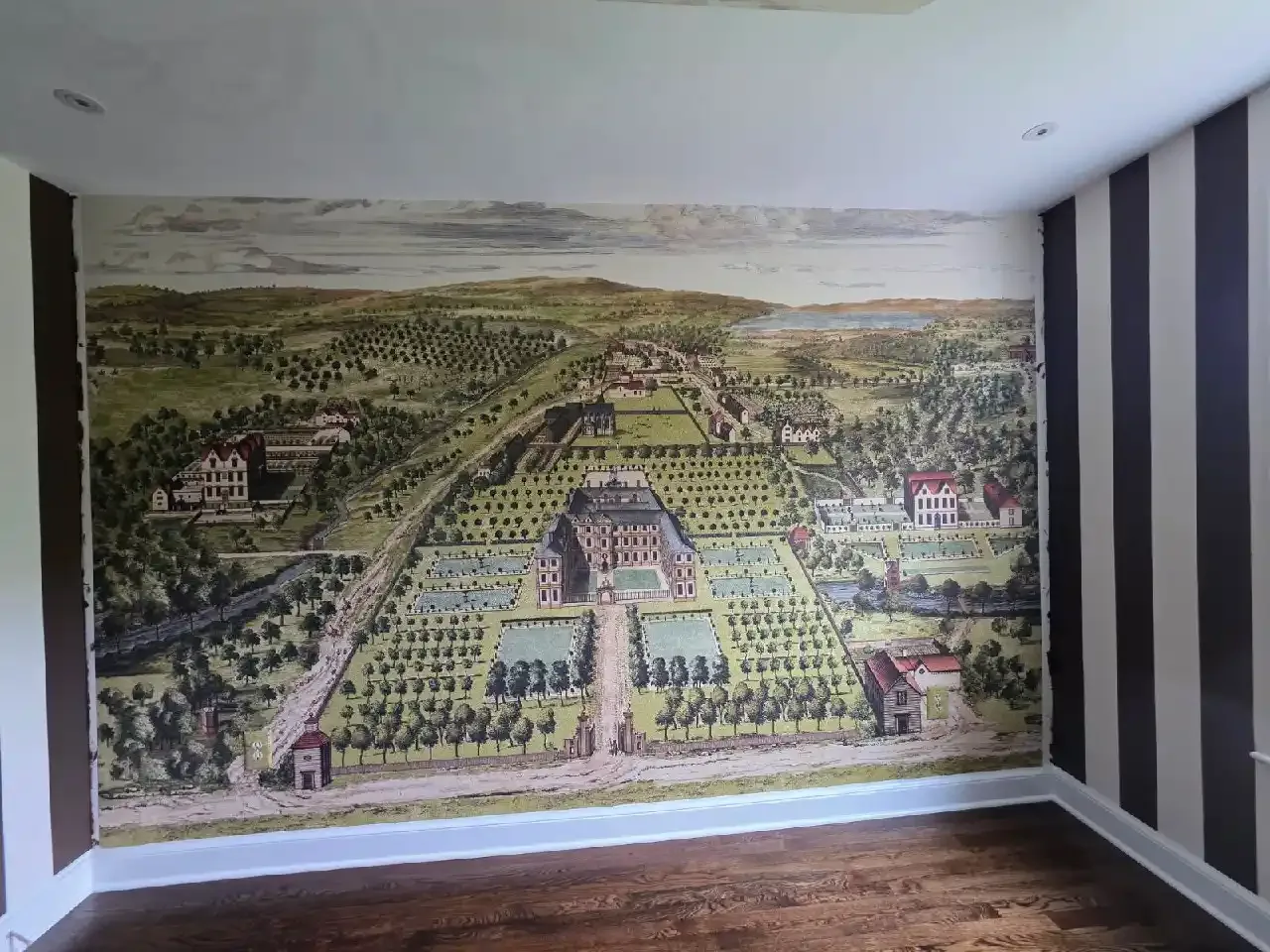 A panoramic landscape mural fitted across a room wall
